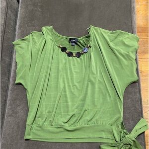 Green short sleeve blouse, brown necklace attached to blouse